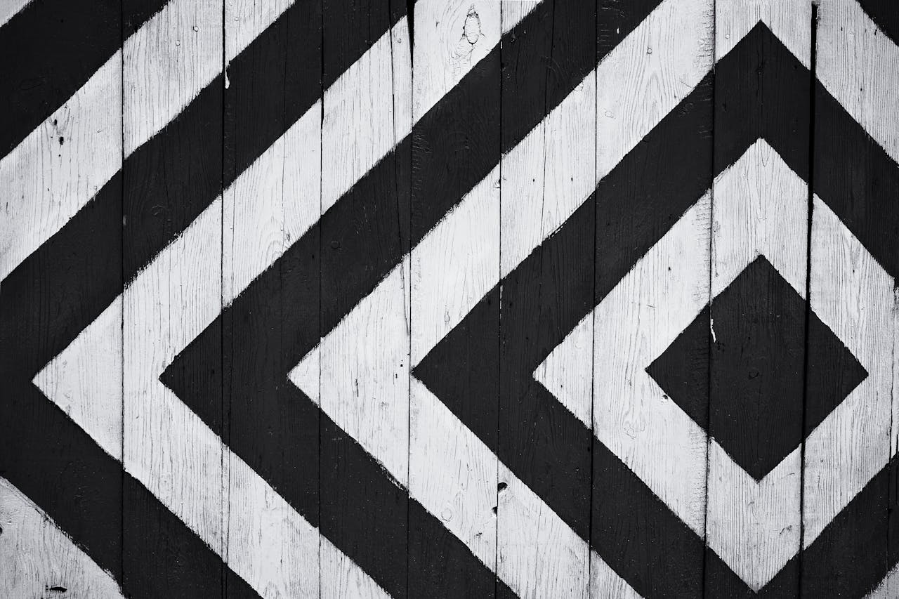 Mastering the First Impression: Your intriguing post title goes here Black and white geometric pattern on wooden planks, ideal for modern design backgrounds.